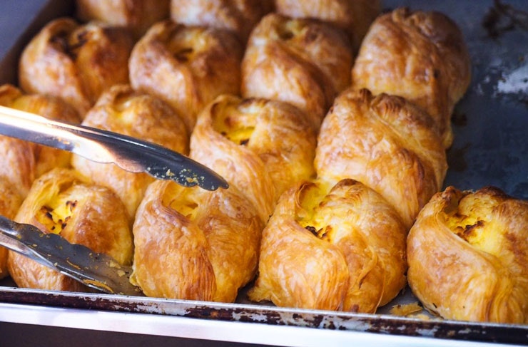 Rows of fresh baked ricotta pastizzi from Pastizzi Cafe in Newtown in Sydney.